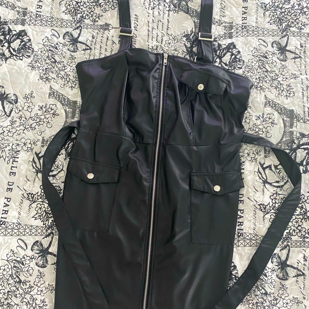 This is a black leather mid drift dress.